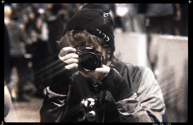 A woman taking a picture with a camera.