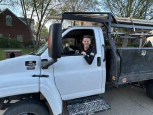 A man sitting in the back of a truck.