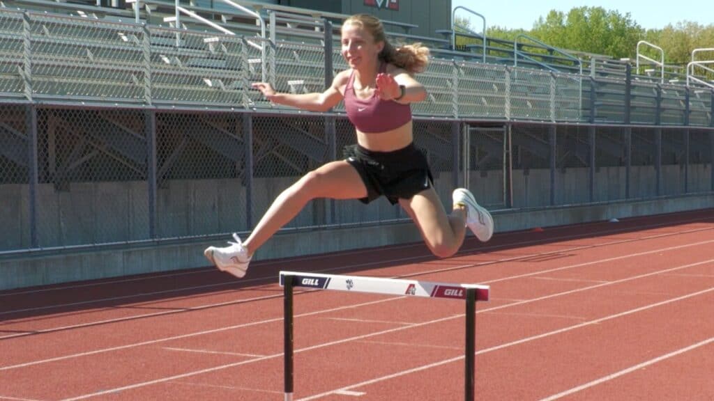 Knoche jumping over a hurdle.