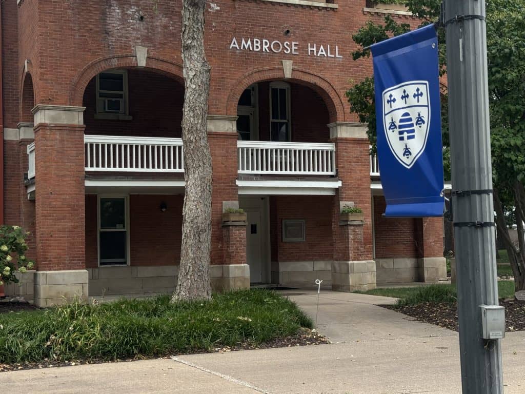 Ambrose hall and a banner on the campus of St. Ambrose University.
