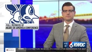 News anchor reporting at KWQC with Heart of America Conference logo in background.